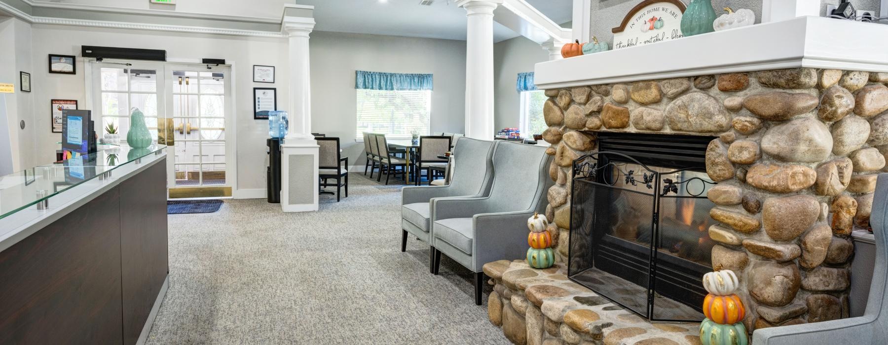 a large room with a fireplace and a stone fireplace