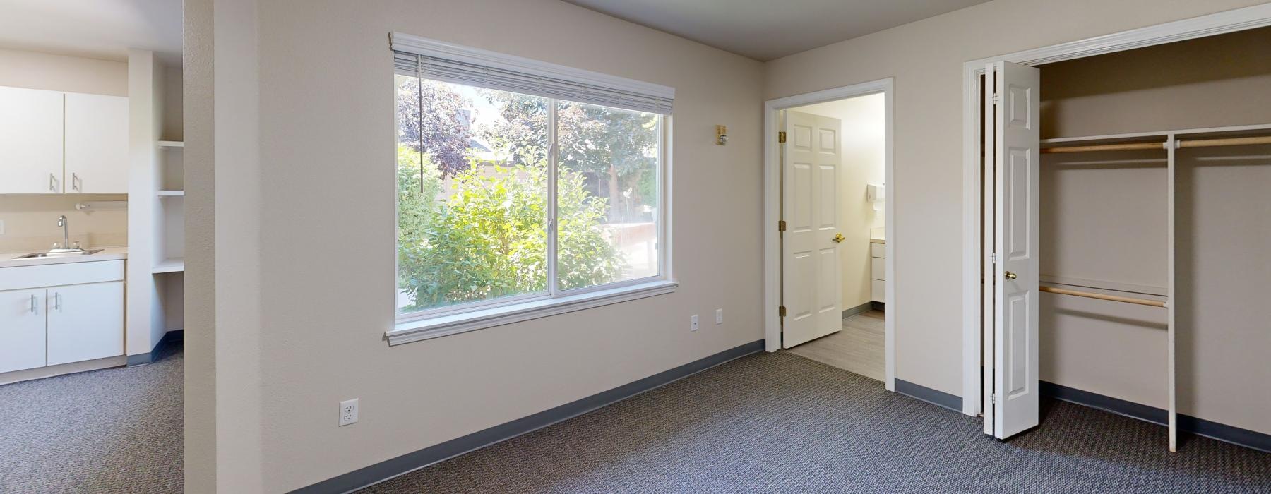 a room with white walls and a window