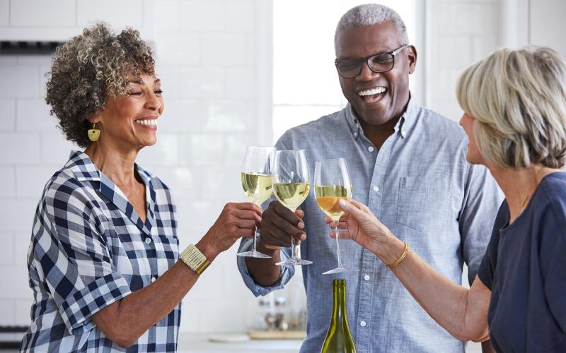 a few people toasting wine glasses