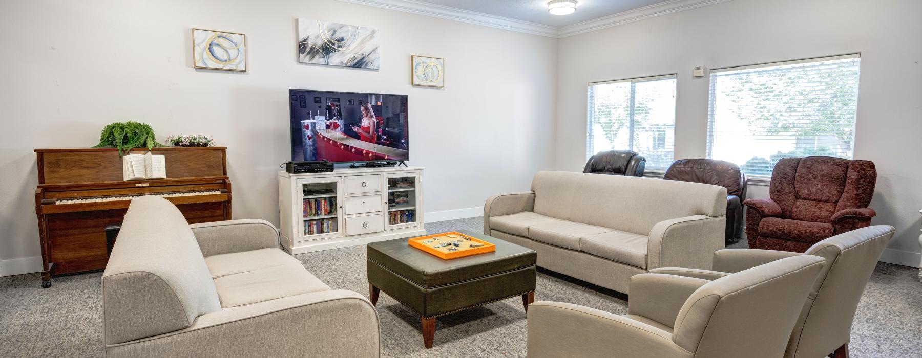 a living room with a tv and couches